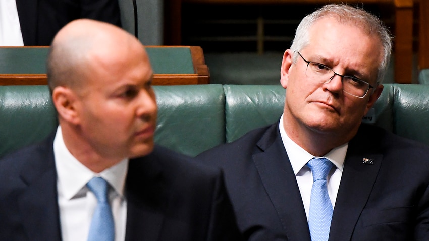 Australian Prime Minister Scott Morrison listens to Australian Treasurer Josh Frydenberg handing down his third Federal Budget in the House of Representatives at Parliament House in Canberra, Tuesday, May 11, 2021. (AAP Image/Lukas Coch) NO ARCHIVING