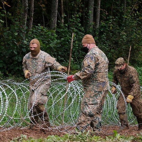 A barbed wire fence is erected on the Belarusian border with Latvia
