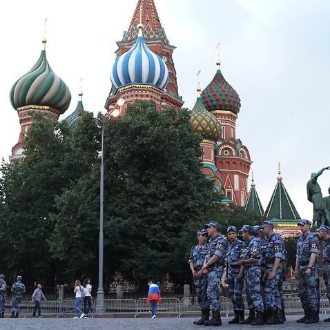 Police wait close to St. Basil's cathedral in Red Square, Moscow.