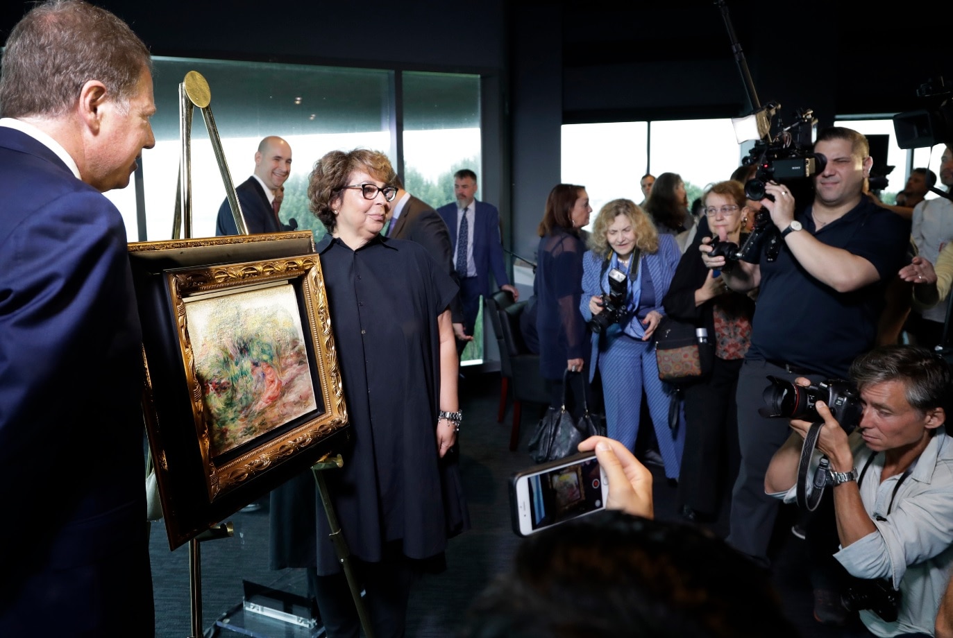 United States Attorney Geoffrey Berman, left, unveils a Renoir painting with Sylvie Sulitzer at a news conference, Wednesday, Sept. 12, 2018, in New York. United States Attorney Geoffrey Berman, left, unveils a Renoir painting with Sylvie Sulitzer at a news conference, Wednesday, Sept. 12, 2018, in New York.