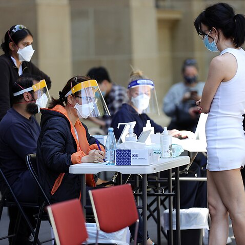 eople are seen at a Cohealth pop-up vaccination clinic at the State Library Victoria