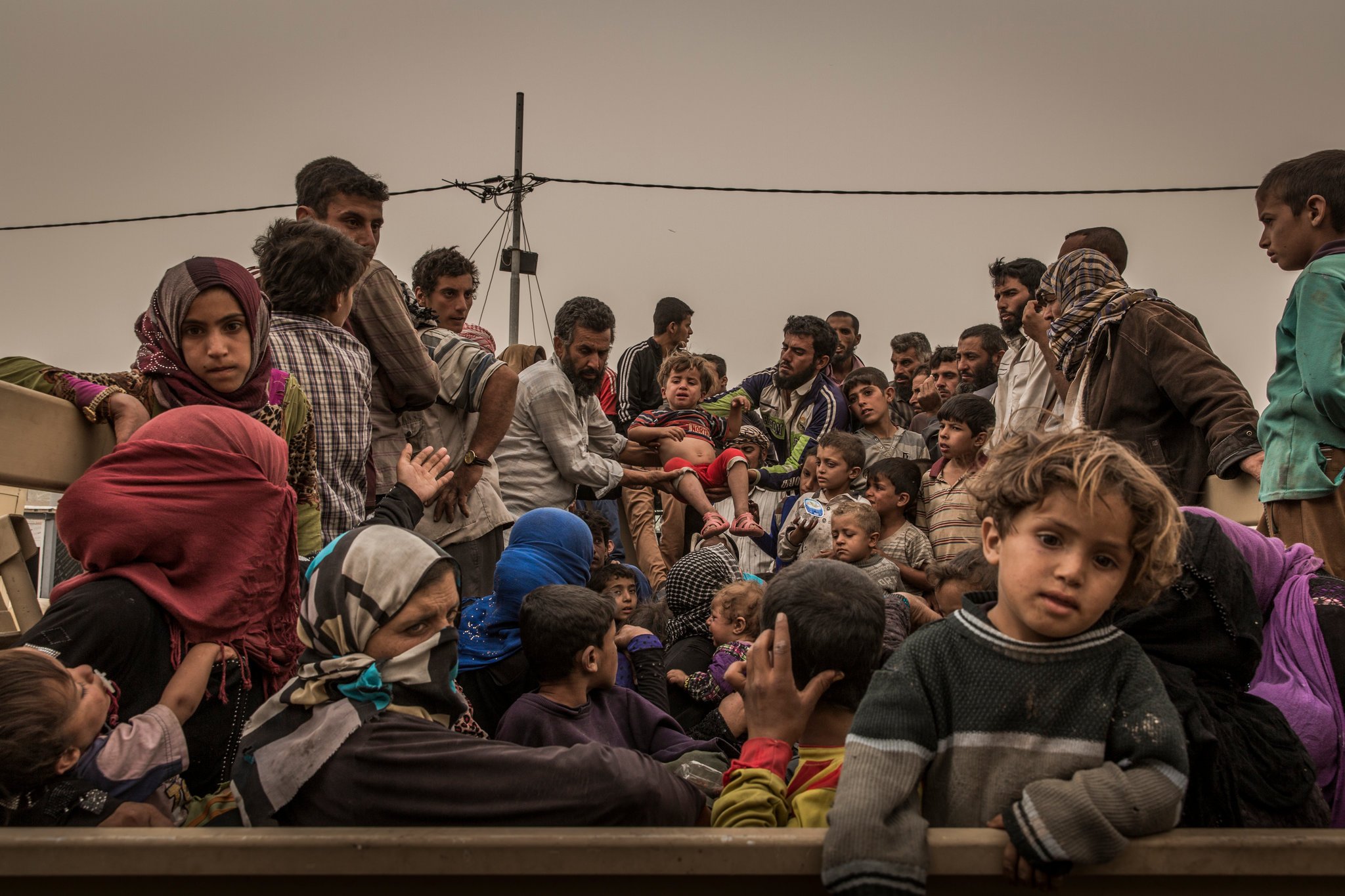 Displaced families at a screening center near Kirkuk, Iraq, after fleeing Islamic State-controlled areas in Hawija in October. Displaced families at a screening center near Kirkuk, Iraq, after fleeing Islamic State-controlled areas in Hawija in October.