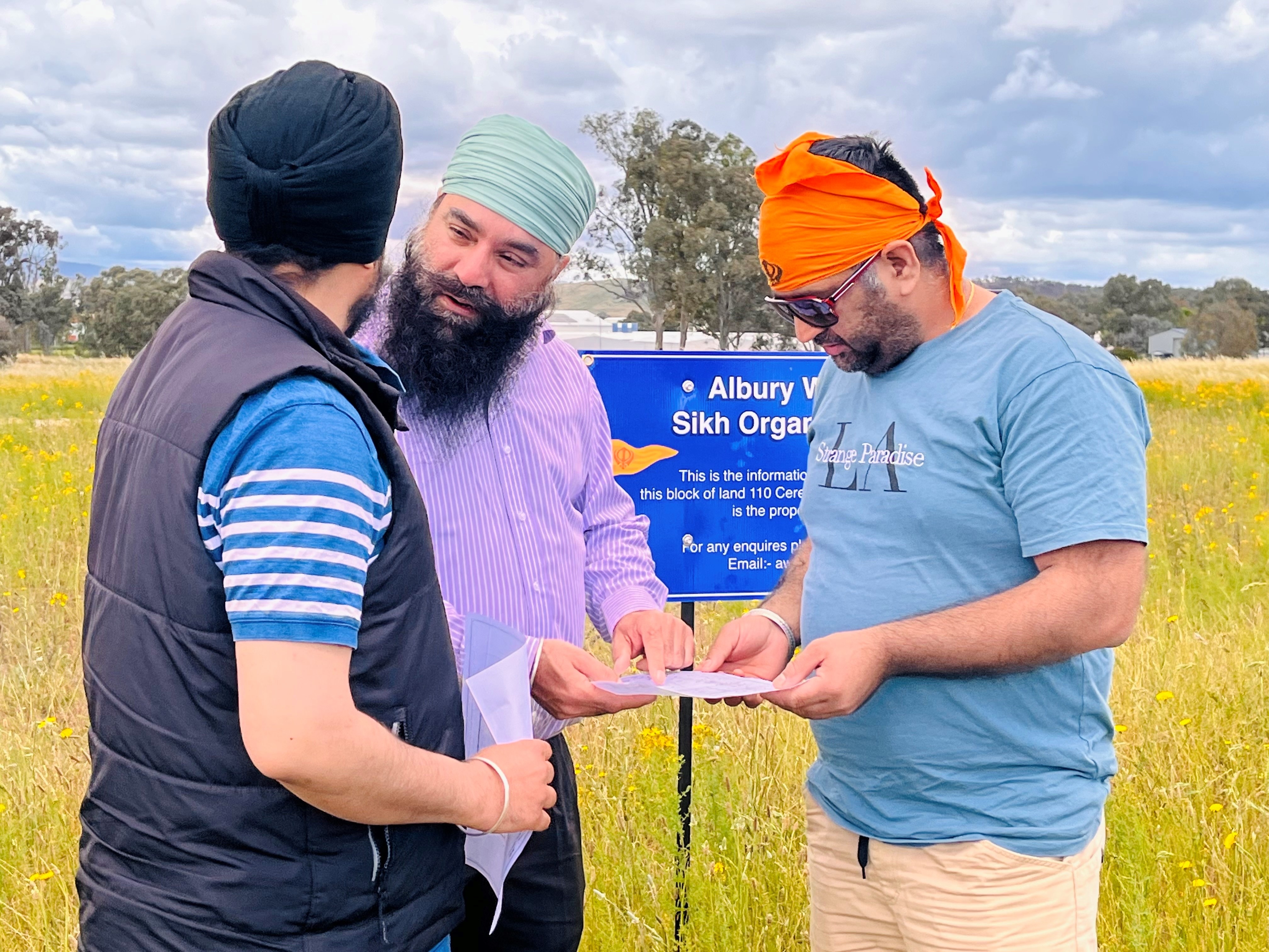 Gurminder Singh (center) chats with other members of the Sikh community at the New Gurdwara site.