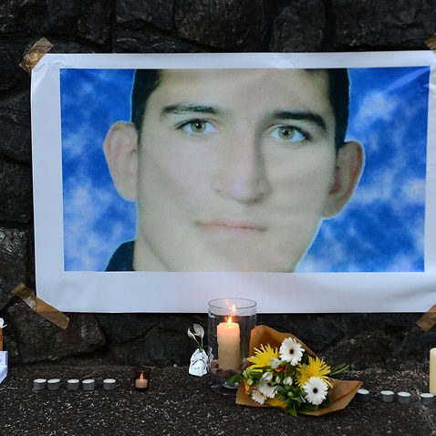 A shrine for Reza Berati is seen during a candlelight vigil in support of asylum seekers in Brisbane, Sunday, February 23, 2014. 