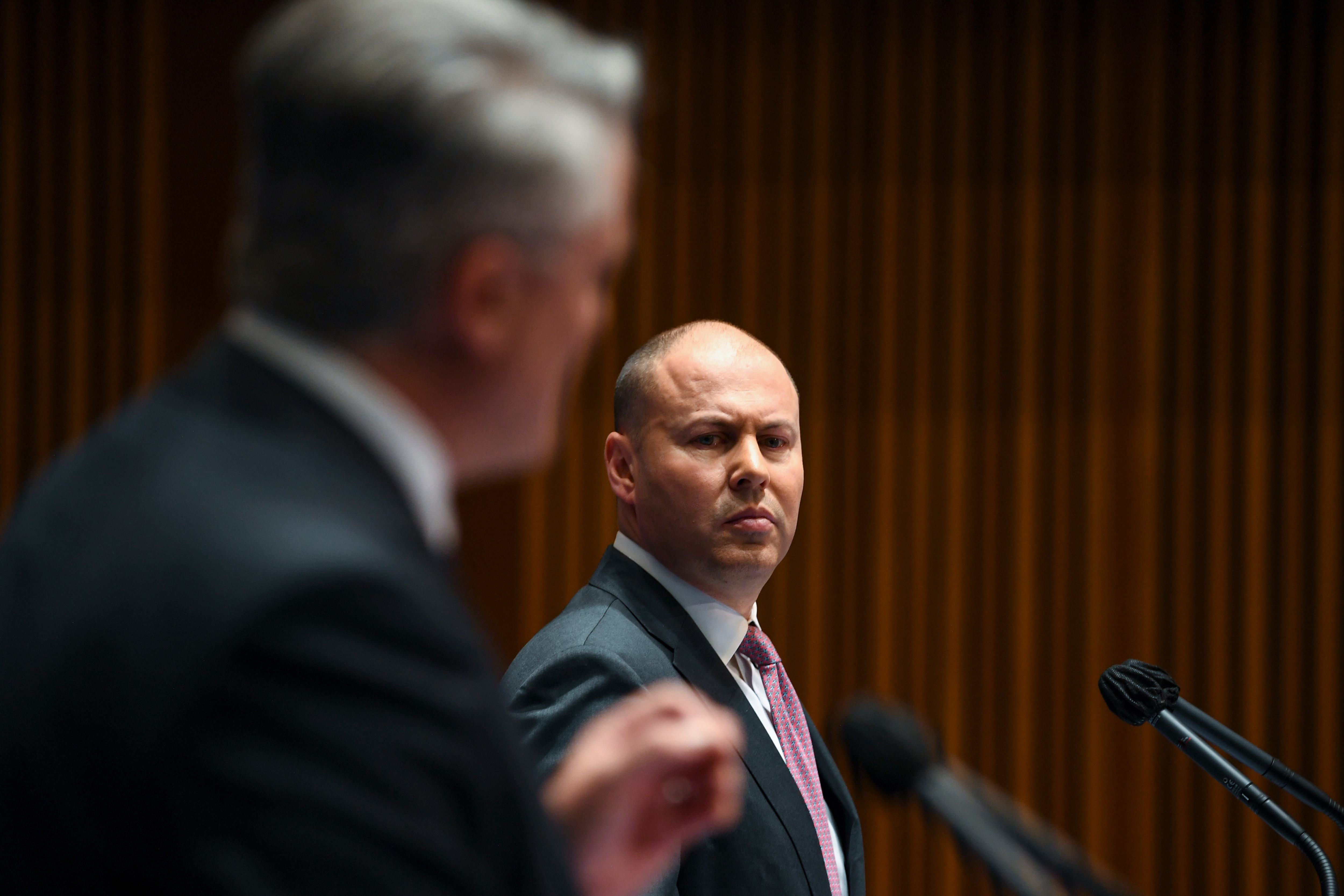 Australian Treasurer Josh Frydenberg listens during a press conference inside the Budget lockup.