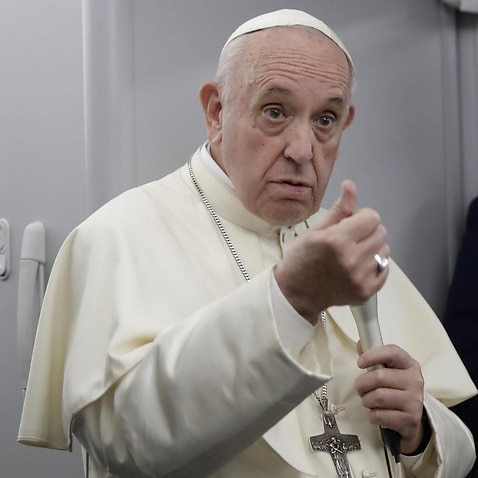 Pope Francis, flanked by Vatican spokesman Alessandro Gisotti.