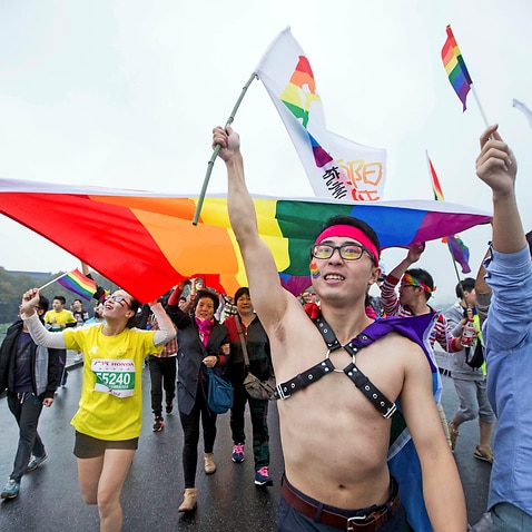 Gay rights activists run with a rainbow flag during the Hangzhou International Marathon in Hangzhou in eastern China's Zhejiang province in 2015. 