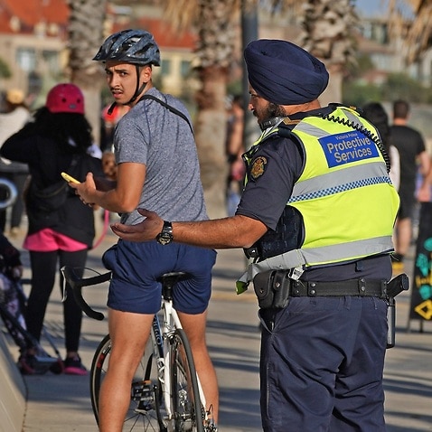 Victoria Police officers patrol St Kilda beach in Melbourne,13 April 2020.  