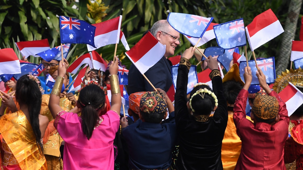 Australian Prime Minister Scott Morrison is greeted by kids in traditional clothing during a welcoming ceremony at Bogor Presidential Palace.