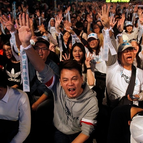 Supporters of Taipei city mayor and city mayoral candidate Ko Wen-je cheer in Taipei, Taiwan, Saturday. 