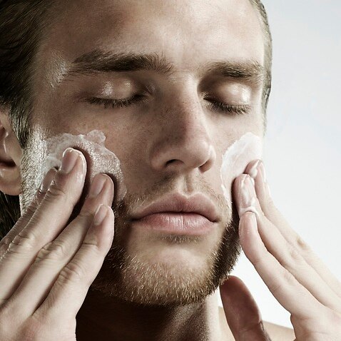 Man applying moisturiser 