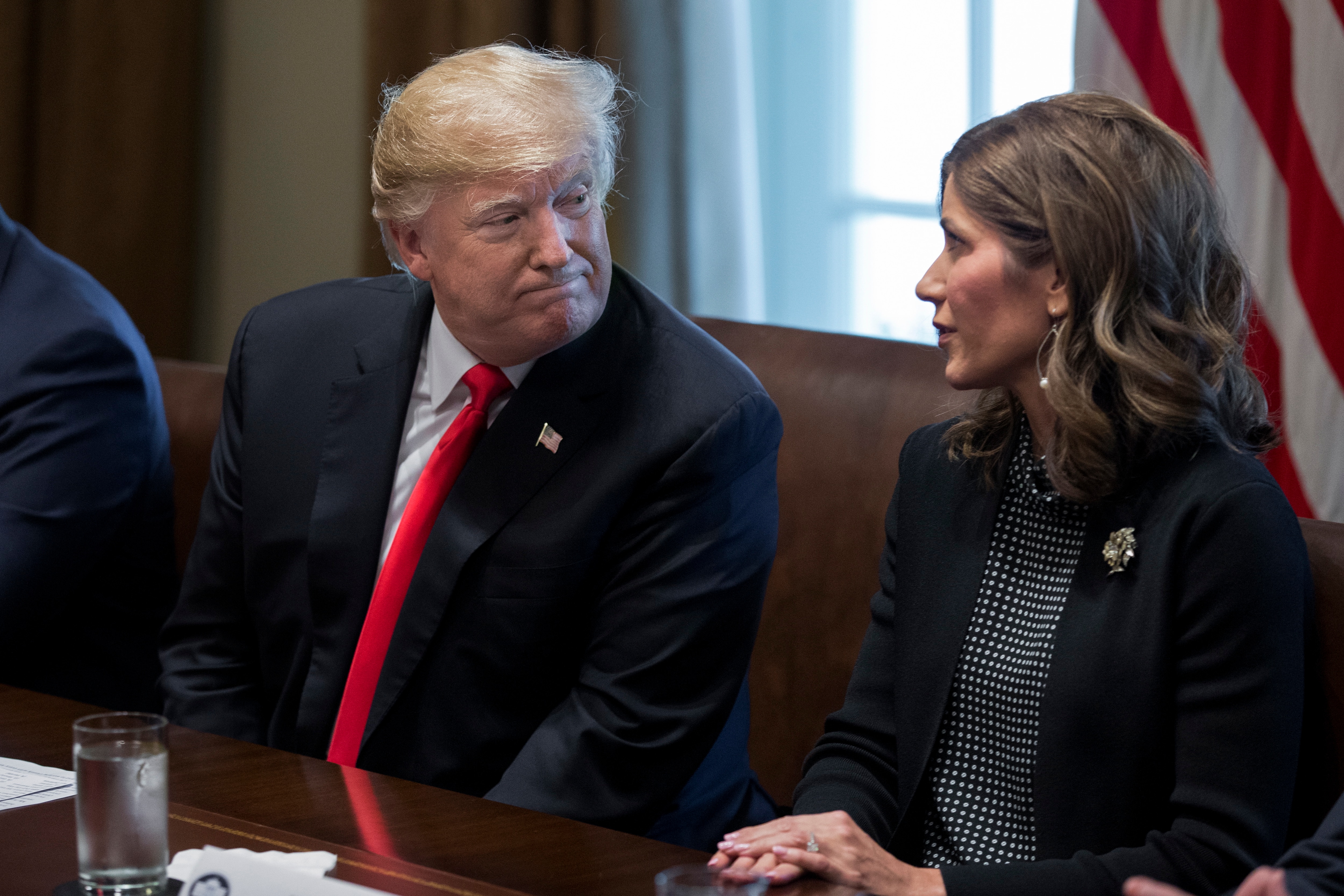 US President Donald Trump sits beside Governor-elect of South Dakota Kristi Noem during a meeting in December 2018.