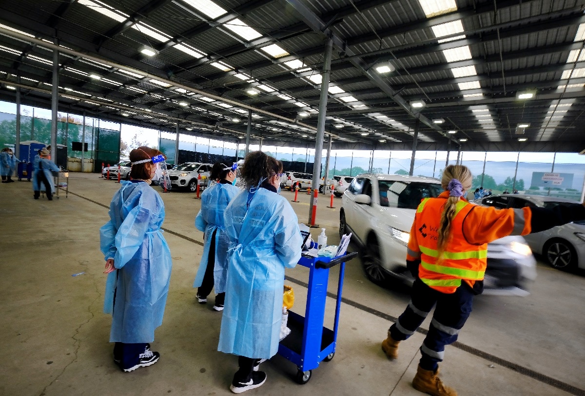 Healthworkers at a drive-through COVID-19 vaccine hub in Melbourne.