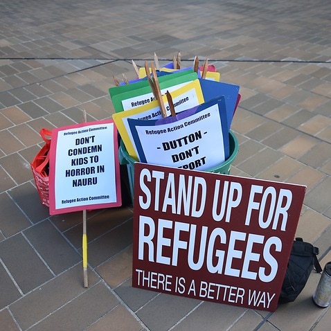 Asylum seeker advocate signs are seen after the High Court of Australia ruling on refugees to Nauru in Canberra, Wednesday, Feb. 3, 2016. 
