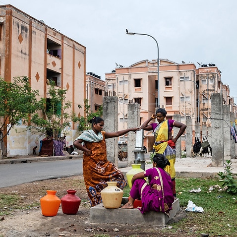 Residents use a hand-pump to collect water at an apartment complex whose buildings are not connected to a central water supply in the OMR district of Chennai, India.