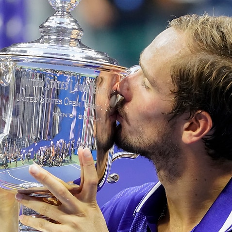 Daniil Medvedev, of Russia, kisses the championship trophy after defeating Novak Djokovic, of Serbia, in the men's singles final of the US Open.