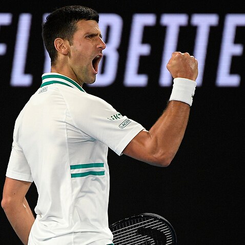 Serbia's Novak Djokovic reacts after winning a point against Russia's Daniil Medvedev in the men's singles final at the Australian Open tennis championship in Melbourne, Australia, Sunday, Feb. 21, 2021.(AP Photo/Andy Brownbill)