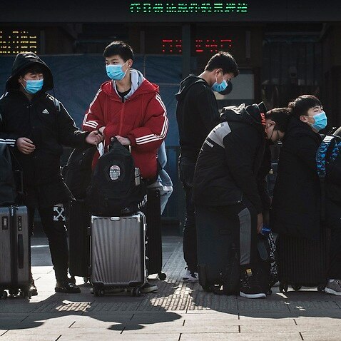 Chinese students wear masks in Beijing.