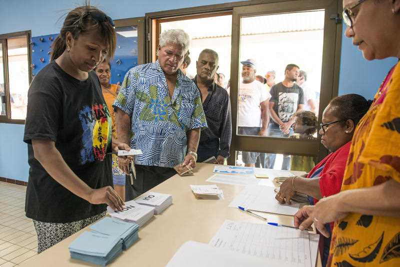 People line up at a polling station in Noumea, New Caledonia, as they prepare to cast their votes as part of an independence referendum, Sunday, Nov. 4, 2018