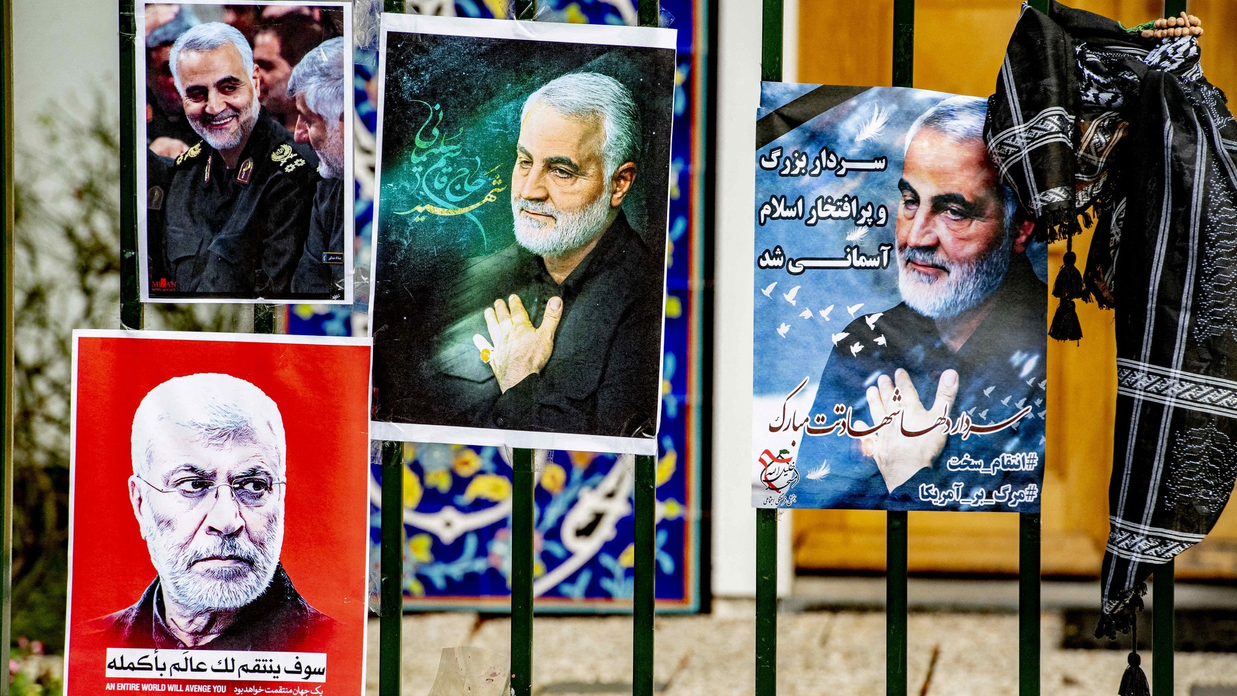 Flowers and posters at the gate of the Iranian embassy in The Hague, Netherlands.