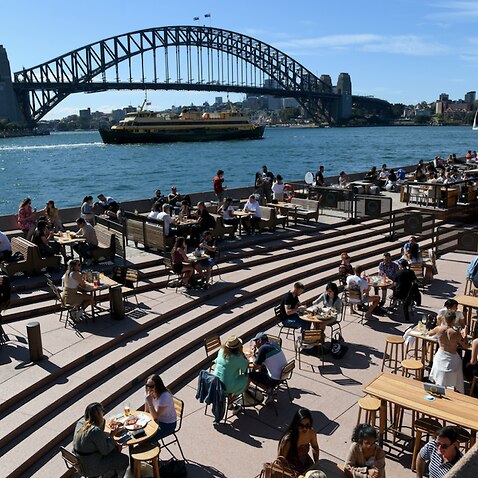 Members of the public are seen at outdoor dinning areas at The Sydney Opera House, in Sydney, Sunday, October 17, 2021.