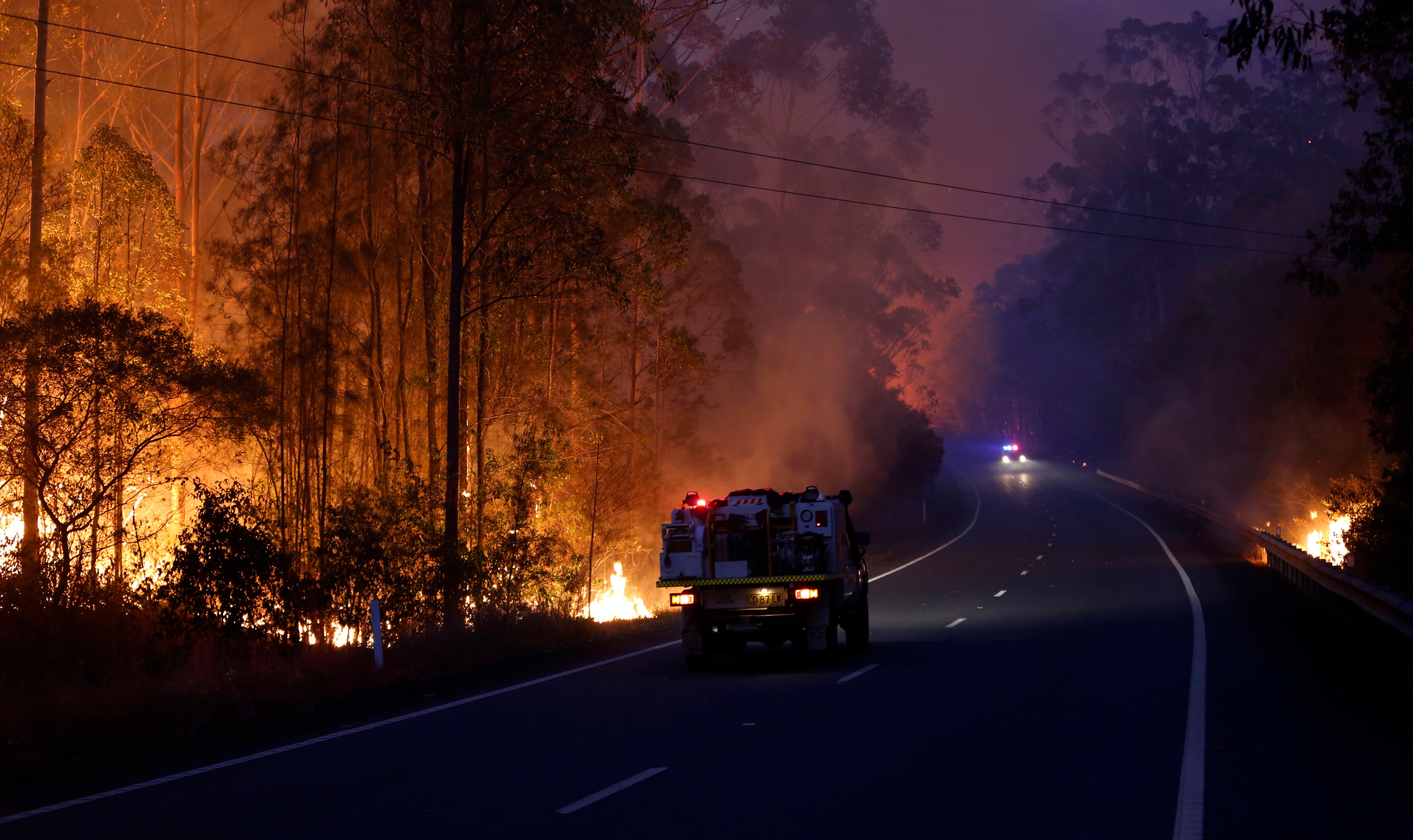 Fires burn on both sides of the Pacific Highway, north of Nabiac in the Mid North Coast region of NSW, Tuesday, November 12, 2019. 