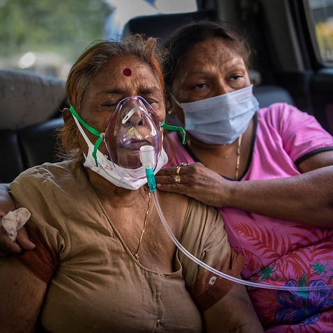 In this April 24, 2021 file photo, a COVID-19 patient receives oxygen provided by a Gurdwara, a Sikh house of worship, in New Delhi, India. 