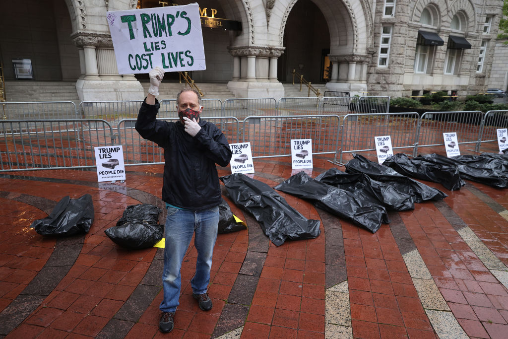 Protesters lay 'body bags' at Trump hotel over coronavirus response