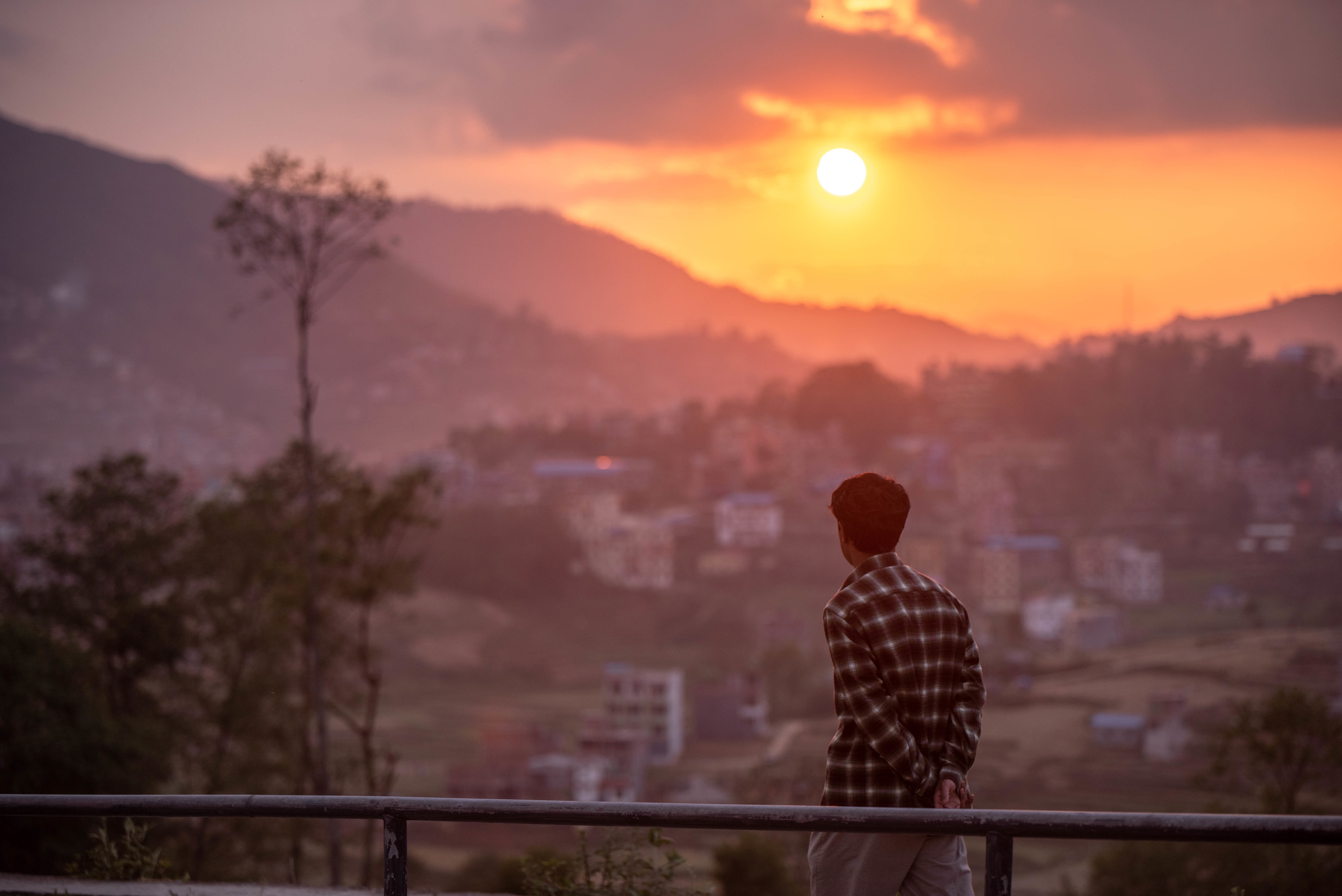 A pedestrian walks past the sun set during the 40th day of lockdown imposed by the Nepal government to contain the spread of covid-19 pandemic. 