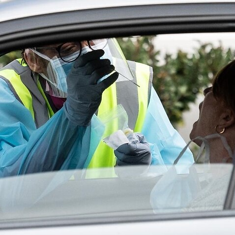 NSW health worker tests motorist for coronavirus.