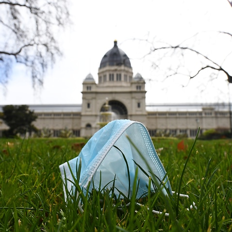 General view of a discarded single use mask face in Carlton Gardens, Melbourne, Wednesday, August 19, 2020. Victoria has recorded 216 new cases of coronavirus and 12 deaths in the past 24 hours (AAP Image/James Ross) NO ARCHIVING