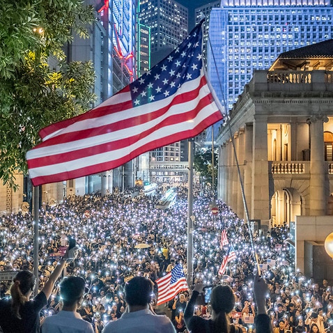 Antigovernment protesters in Hong Kong wave the flag of the United States during a rally in Hong Kong on Oct. 14, 2019. 