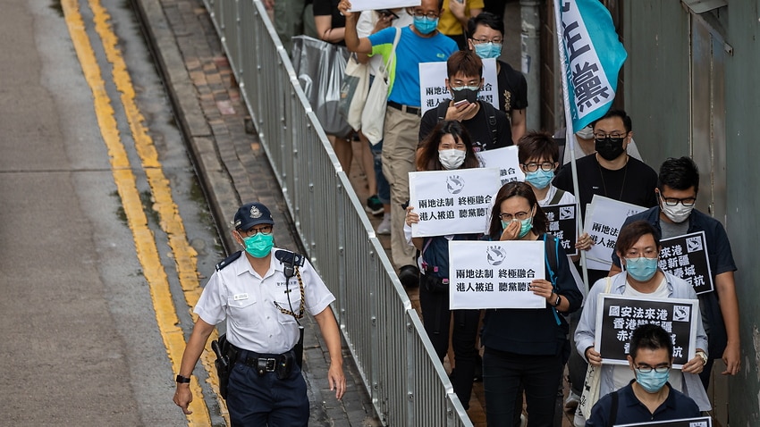 Lawmakers and activists make their way to China's Liaison Office during a rally against a new security law in Hong Kong, 22 May.