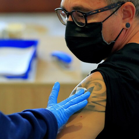 A Romanian man receives a Pfizer vaccine dose