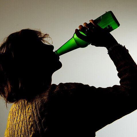 a woman drinking alcohol