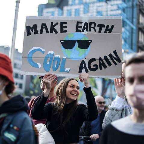 Protesters take part in a demonstration in Brussels ahead of the COP26 climate summit.