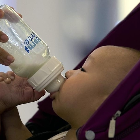 A baby is fed milk from a bottle in Beijing, China