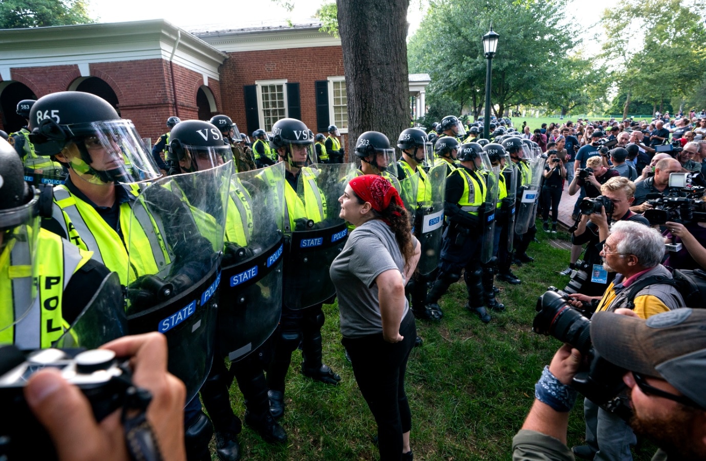 State police form a line as students from the University of Virginia (UVA), along with residents and anti-fascists, march across the UVA campus 