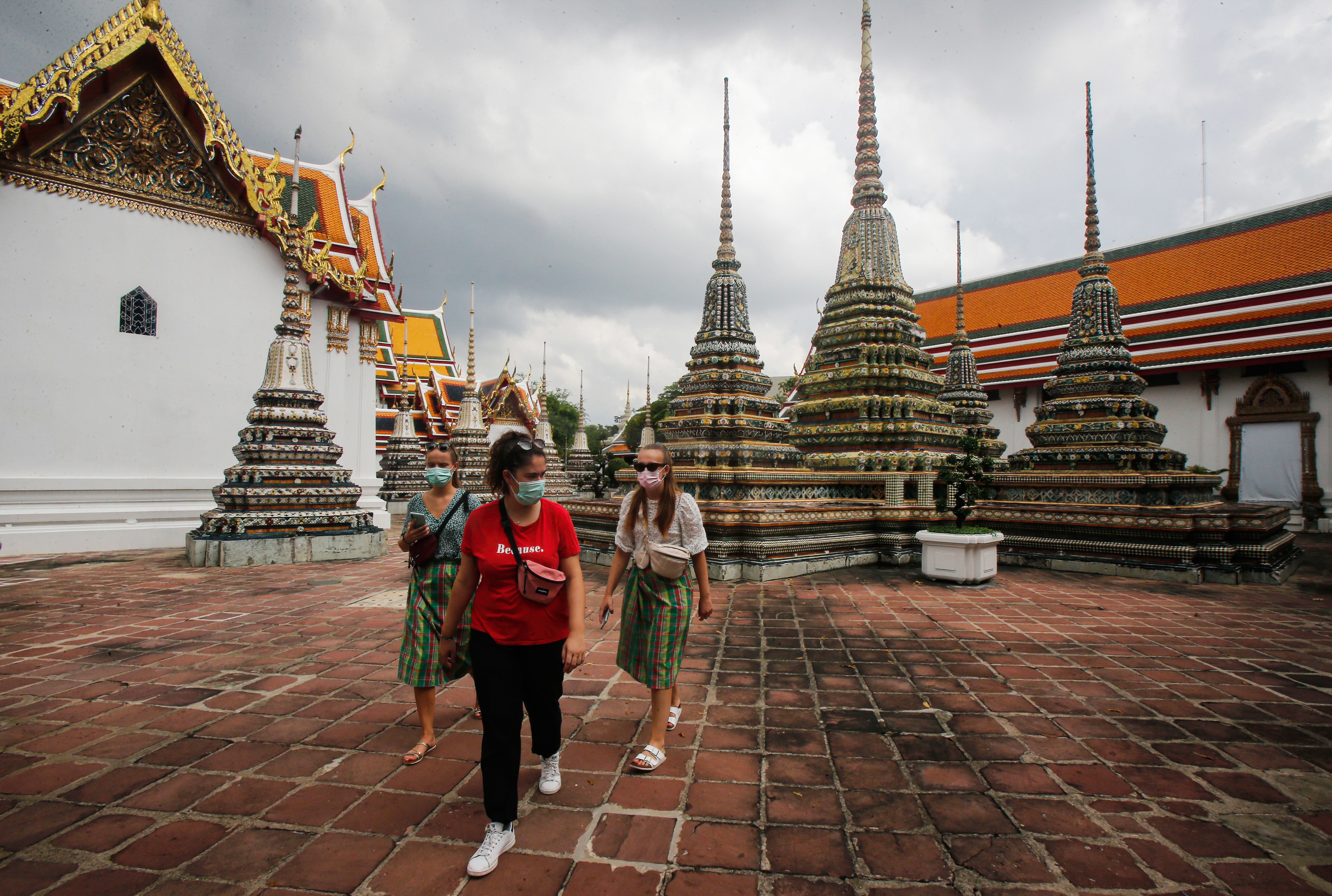 Tourists visit a temple in Bangkok.