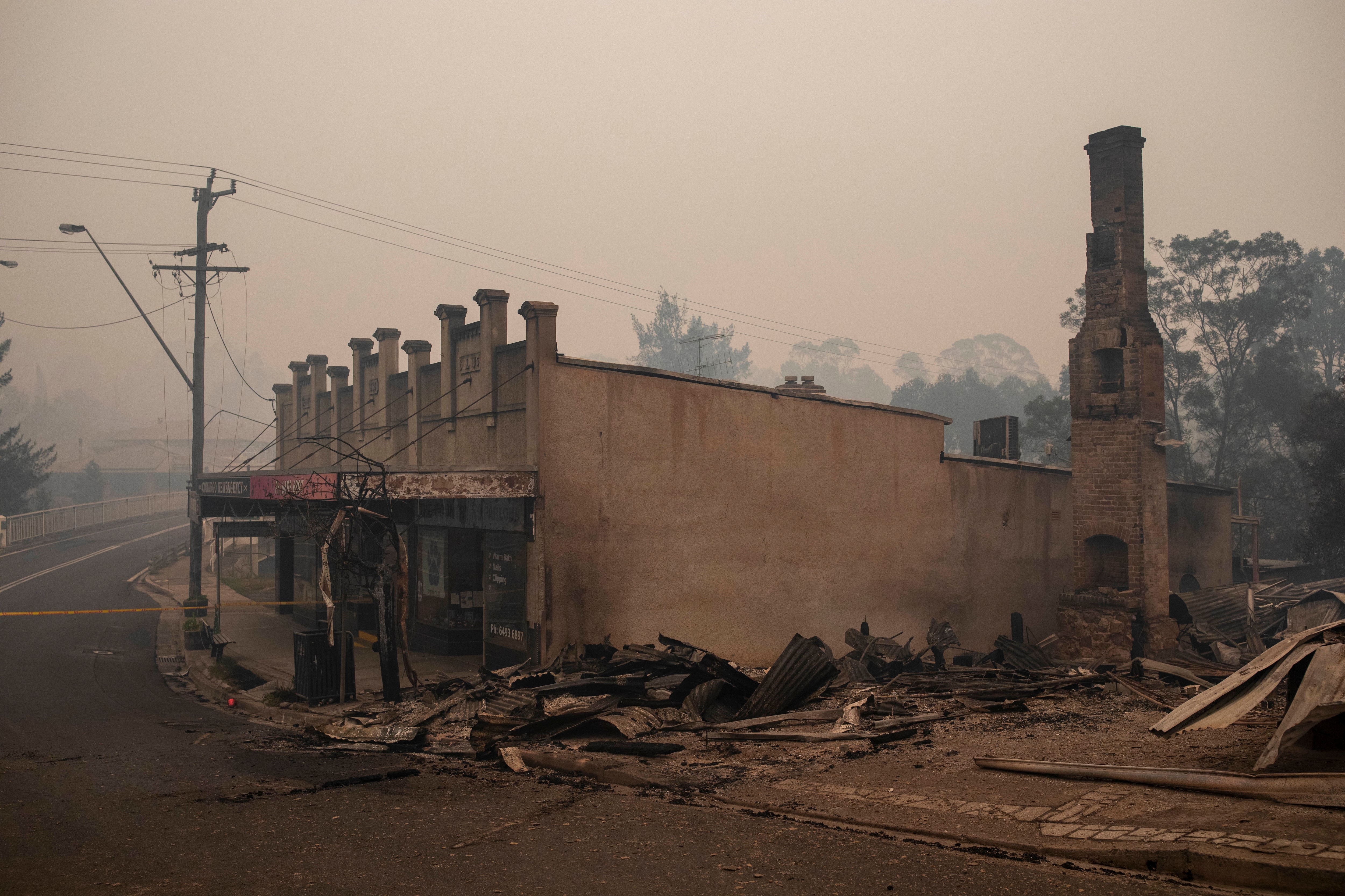 Destroyed buildings are seen in Cobargo, NSW, Wednesday, January 1, 2020. Several bushfire-ravaged communities in NSW have greeted the new year under immediate threat. (AAP Image/Sean Davey) NO ARCHIVING