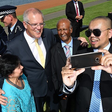 Prime Minister Scott Morrison takes a selfie with newly-sworn citizens at an Australia Day Citizenship Ceremony