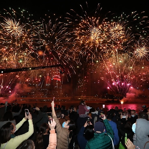 People celebrate in Brisbane after the International Olympic Committee voted to confirm the city will host the 2032 Summer Olympics, on 21 July, 2021.
