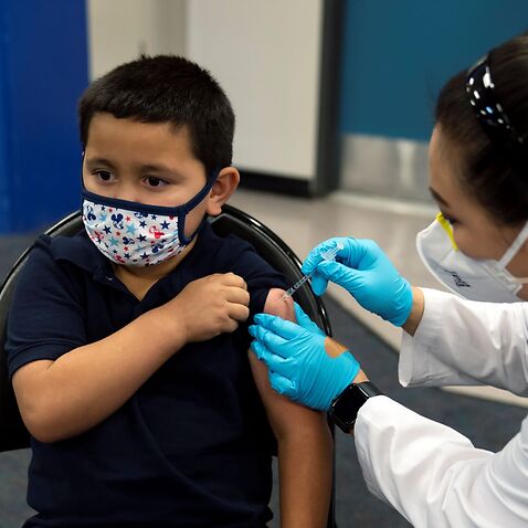 Six-year-old Eric Aviles receives the Pfizer COVID-19 vaccine in California