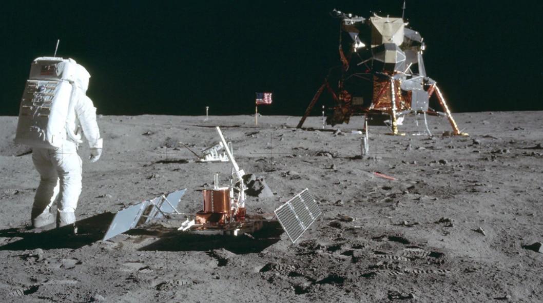Astronaut Buzz Aldrin Jr. stands next to the Passive Seismic Experiment device on the surface of the the moon. 