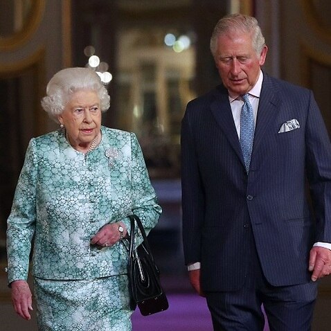 Queen Elizabeth and Prince Charles arrive for the formal opening of the Commonwealth Heads of Government Meeting.
