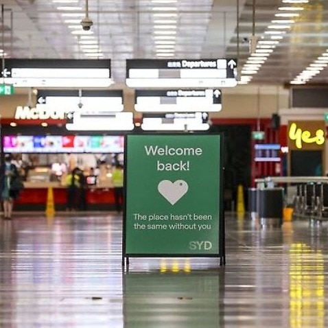 A sign is displayed inside the arrivals hall at the international airport in Sydney
