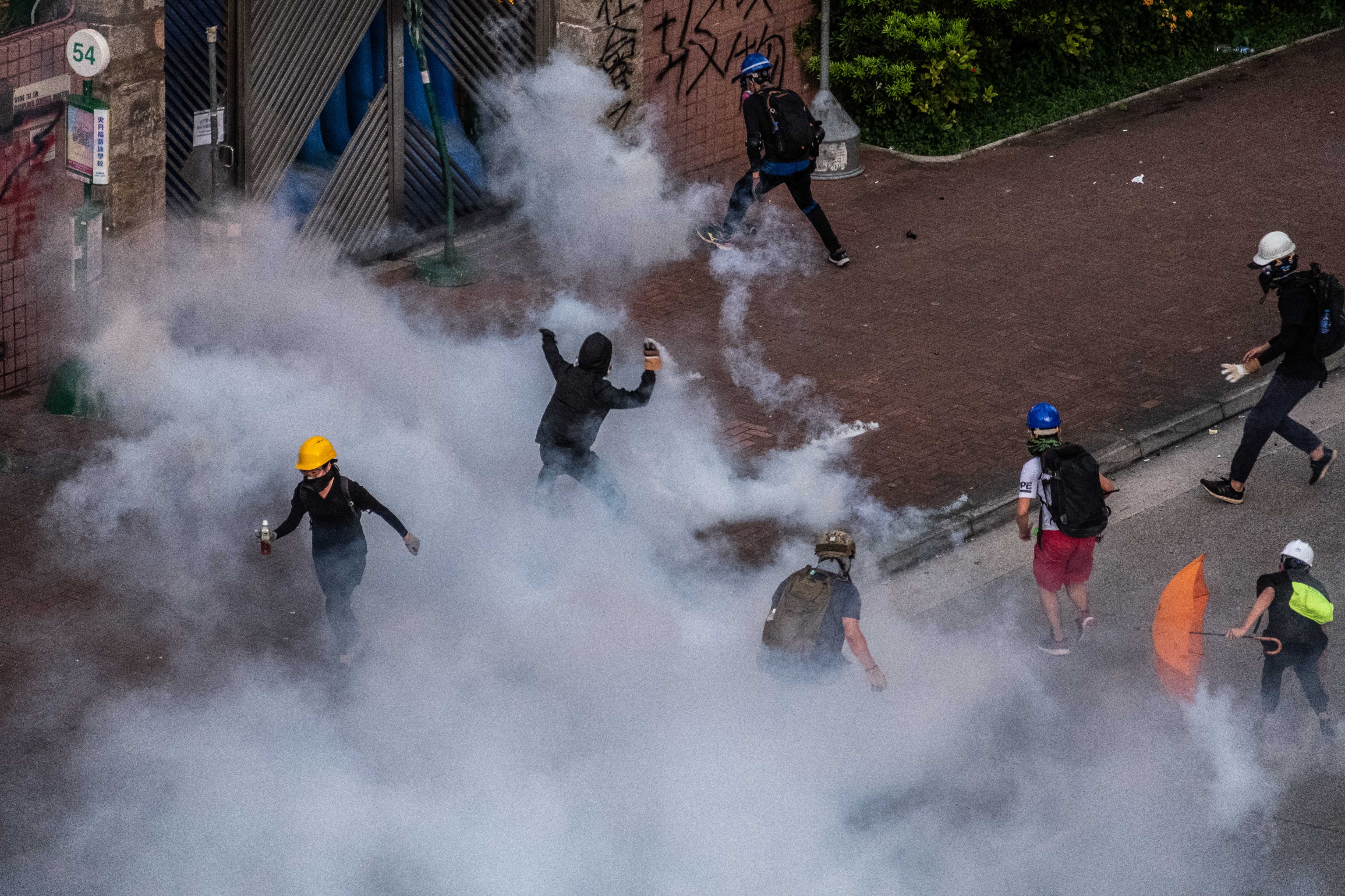 Riot police officers fire teargas during clashes with protestors in the Wong Tai Sin District district of Hong Kong, on Monday, Aug. 5, 2019. Riot police officers fire teargas during clashes with protestors in the Wong Tai Sin District district of Hong Kong, on Monday, Aug. 5, 2019. A top Chinese official overseeing Hong Kong affairs said on Wednesday that the city was experiencing its worst cr