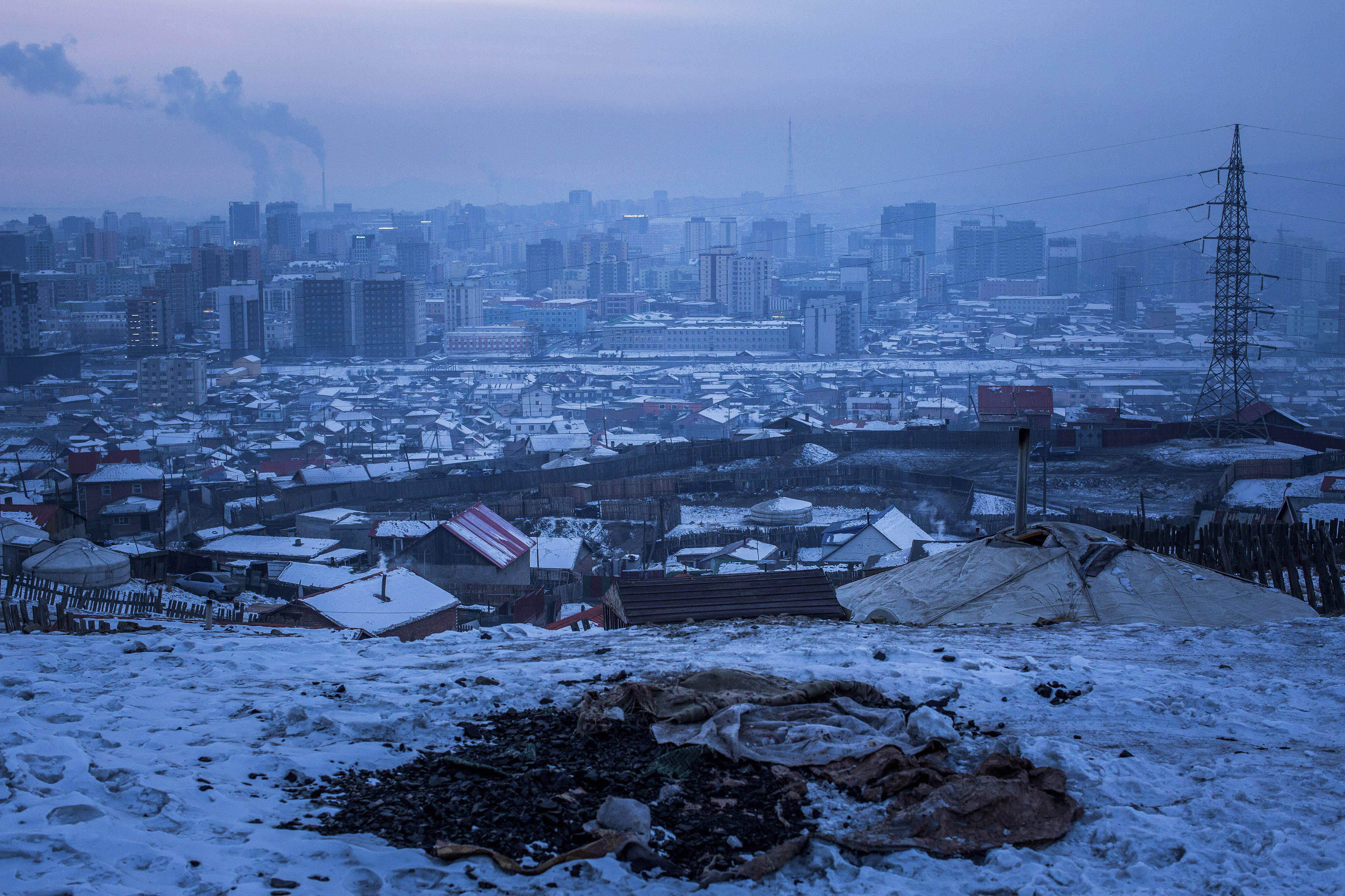 A pile of coal exposed in the snow on an abandoned lot in Ulaanbaatar, Mongolia. A pile of coal exposed in the snow on an abandoned lot in Ulaanbaatar, Mongolia.