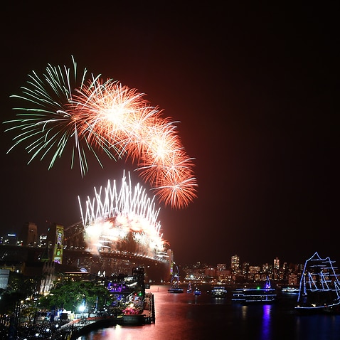 Fireworks explode to welcome in the New Year over the Sydney Harbour Bridge and the Sydney Opera House.
