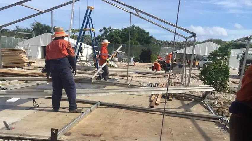 Workmen dismantle the old tents on Nauru.